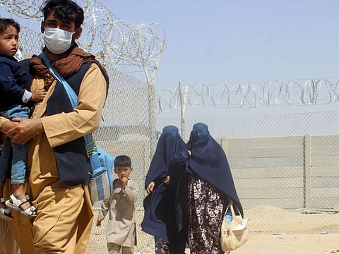 A family from Afghanistan cross into Pakistan via Friendship Gate crossing point in the Pakistan-Afghanistan border town of Chaman, Pakistan, on September 4, 2021.