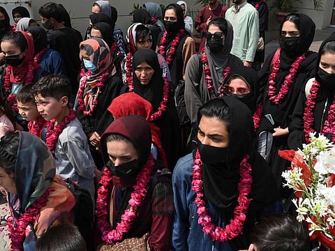 Afghanistan's national girls football team arrive with their family members at the Pakistan Football Federation (PFF) in Lahore on September 15, 2021