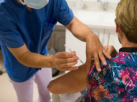 A healthcare worker administers a third dose of the Pfizer-BioNTech Covid-19 vaccine at a senior-living facility in Paris, France, on Thursday, Sept. 16, 2021. France is on the forefront of a carrot-and-stick approach that seeks to maintain a high level of vaccinations.