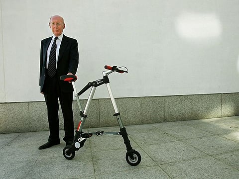 In this file photo taken on July 12, 2006 British transport pioneer Sir Clive Sinclair poses for a photograph during the launch of his A-bike, during a press launch at the Design Museum in London.