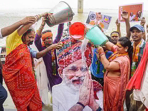 BJP supporters perform rituals on the banks of river Ganga to celebrate 71st birthday of Prime Minister Narendra Modi, in Patna, on Friday.