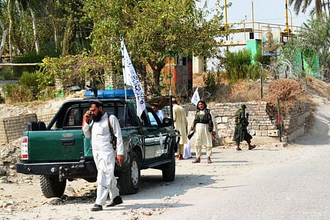 Taliban members inspect near the site of a blast in Jalalabad on September 18, 2021.