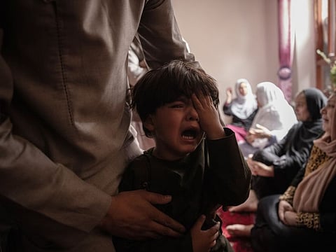 A boy cries in Kabul, Afghanistan on August 30, 2021, after his sister was killed in a US drone strike a day earlier.
