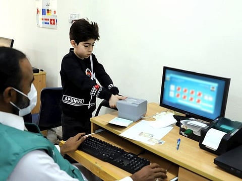 A young Afghan refugee is biometrically registered for a smartcard at a centre in Rawalpindi, Pakistan.