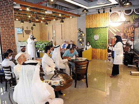 A healthcare practitioner addressing an informal gathering under the Memory Café initiative in Dubai