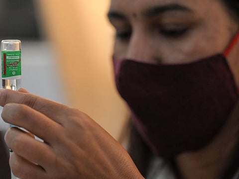 A health worker prepares a dose of the Covishield vaccine at a temporary health centre in New Delhi on September 22, 2021.