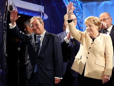 Angela Merkel, Germany's chancellor, and Armin Laschet, chancellor candidate for the Christian Democratic Union (CDU), during an election campaign rally in Stralsund, on September 21, 2021.