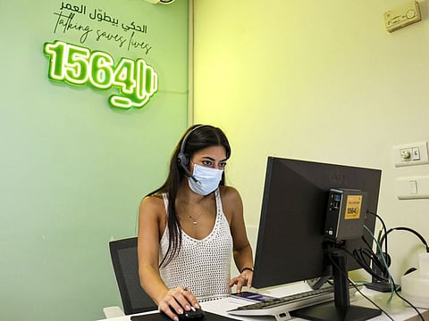 Christine Al Zein, a volunteer operator, answers calls at Embrace, an NGO which runs a suicide-prevention hotline, in Lebanon's capital Beirut on September 1, 2021.