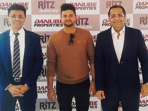 Suresh Raina being flanked by Anis Sajan (left) and Rizwan Sajan during a promotional event in Dubai.