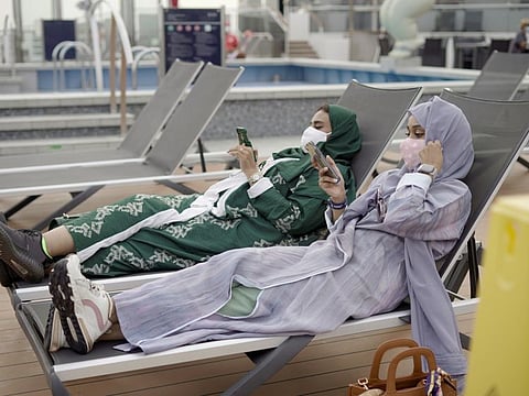 Saudi tourists relax on the viewing deck of a cruise ship during their leisure trip to Red Sea, in Jeddah, Saudi Arabia, September 20, 2021.