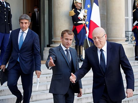 French President Emmanuel Macron and Lebanon's Prime Minister Najib Mikati arrive to deliver a joint statement after a working lunch at the Elysee Palace in Paris on September 24.