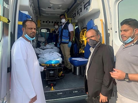Naseer Vatanappally (left), Kareem Valapad and Sahil Nadapuram see off M.A. on a stretcher on Thursday.