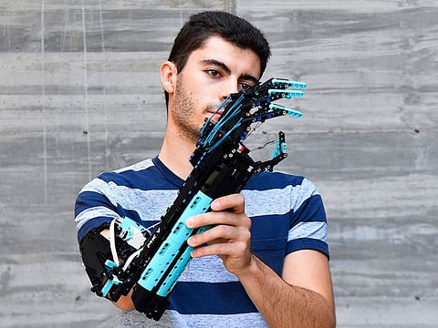 2017 Guinness World record holder and 2020 Lego Masters France winner, Andorran university student David Aguilar, 22, affected by Poland syndrome, poses with his self-built prosthetic arm, made with Lego pieces.