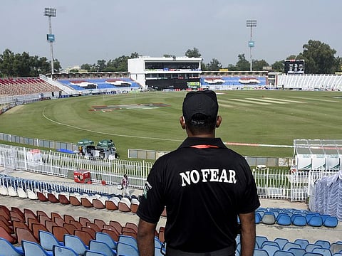 A member of the Police Elite Force stands guard at the Rawalpindi Cricket Stadium in Pakistan