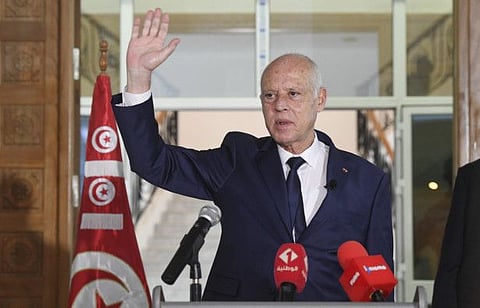 Tunisian President Kais Saied waves to Tunisian citizens as he delivers a speech during his visit to Sidi Bouzid, Tunisia, on September 20, 2021.