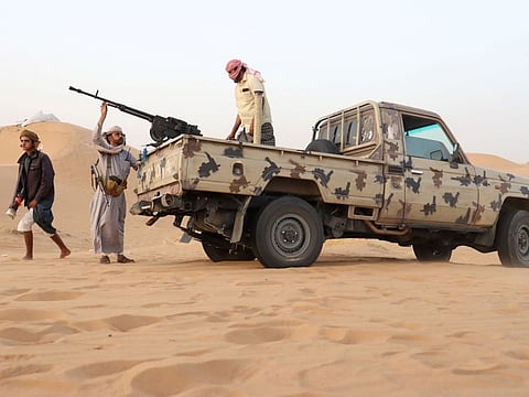 Armed men loyal to the government forces guard a site near the Safer oil fields in Marib in a file photo.