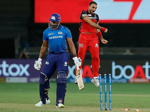Mumbai Indians’ Kieron Pollard is bowled by Harshal Patel of Royal Challengers Bangalore in the IPL 2021 match in Dubai on September 26, 2021.