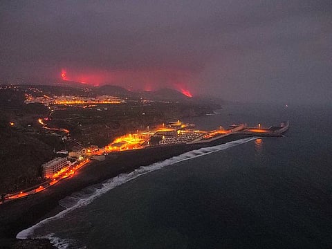 Lava is seen and smoke rises following the eruption of a volcano, in the Port of Tazacorte, on the Canary Island of La Palma, Spain.