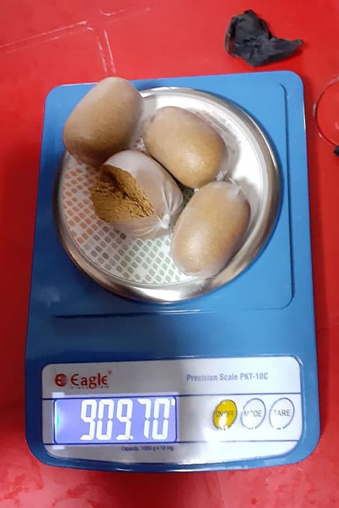 In this handout photograph released by the Central Industrial Security Force of India on September 29, 2021 shows a scale with gold paste packs recovered from the rectum of a smuggler, in Imphal.