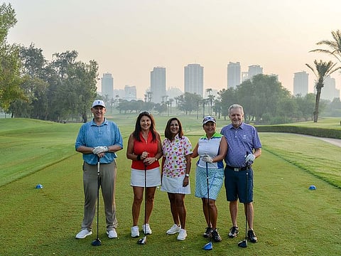 Boyd Edmondson, Naima Maya, Amerjeet Radia, Josie Tracey and Mike Tracey on the first tee at the Majlis Course, Emirates Golf Club