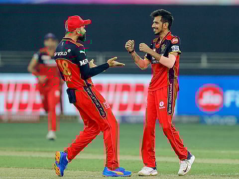 Yuzvendra Chahal (right) of Royal Challengers Bangalore celebrates the wicket of Liam Livingstone of Rajasthan Royals with his captain Virat Kohli during their IPL match in Dubai on Wednesday.