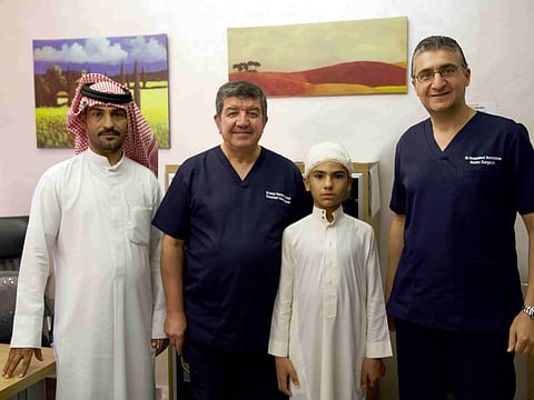 Mohammad Munef Turfah post-surgery with his father Munef Turfah Wadi Alghadir and surgeons Dr Imad Hashim Ahmad (second left) and Dr Mohammad Nooruldeen Jabbar (right) at the Canadian Specialist Hospital, Dubai.