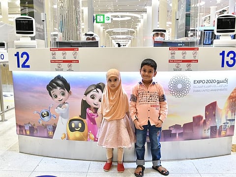 There are dedicated counters for families arriving at Dubai International Airport Terminal 3, bearing the Expo 2020 Dubai logo and pictures of the mascots.