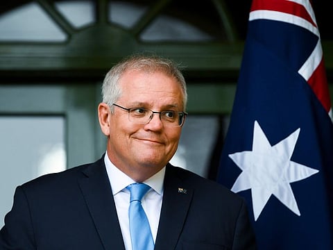 Australian Prime Minister Scott Morrison discusses travel restrictions during a press conference in Canberra, Friday, Oct. 1, 2021. Australia has outlined plans to lift its pandemic ban on its vaccinated citizens traveling overseas from November, but no date has yet been set for welcoming international tourists back.