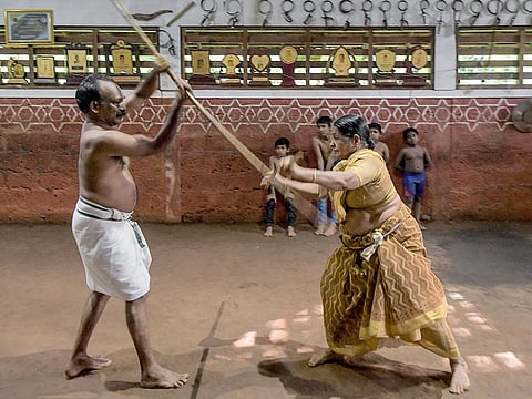 Meenakshi Amma (R) along with her son Sajeev Kumar, practitioners and teachers of 'Kalaripayattu', a traditional martial art originated in Kerala, sparring at their family-run Kadathanadan Kalari Sangam school in Vatakara in the Kozhikode district of the state of Kerala.