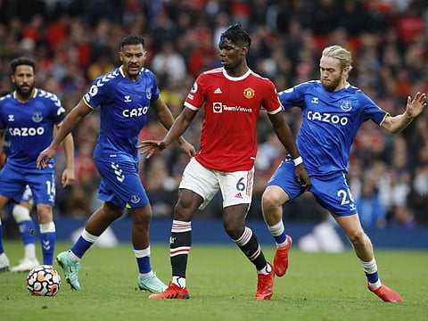 Manchester United's Paul Pogba in action with Everton's Tom Davies and Salomon Rondon.