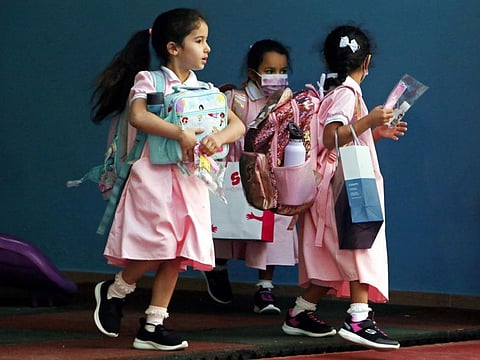 Students arrive at a school as in-person classes resume amid the COVID-19 pandemic in Kuwait city on September 26, 2021.