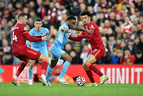 Manchester City's Raheem Sterling in action with Liverpool's Curtis Jones and Jordan Henderson at Anfield.