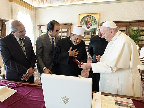Pope Francis and Egyptian Islamic scholar and the current Grand Imam of Al Azhar mosque, Sheikh Ahmed Al Tayeb (centre) exchanging gifts during a private audience at The Vatican, within the conference "Faith and Science: Towards COP26".