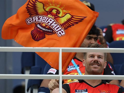 David Warner watches Sunrisers Hyderabad play the Kolkata Knight Riders in the IPL 2021 game in Dubai on October 4, 2021.