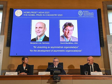 Member of the Nobel Committee for Chemistry Pernilla Wittung Stafshede, Goran K Hansson, Secretary General of the Royal Swedish Academy of Sciences and member of the Nobel Committee for Chemistry Peter Somfai address a press conference to announce the winners of the 2021 Nobel Prize in Chemistry (On display) Germany's Benjamin List (left) and David MacMillan of the United States, at the Royal Swedish Academy of Sciences in Stockholm, Sweden, on October 6, 2021.