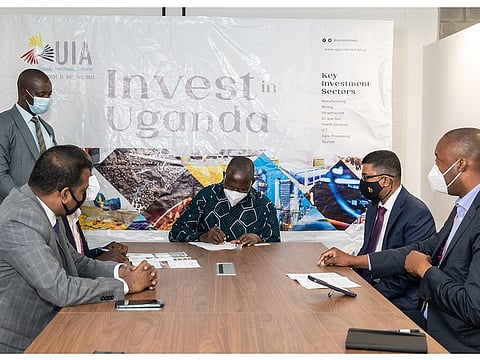 Ugandan Minister of Finance, Planning and Economic Development Matia Kasaija signs the investment deals at the ceremony.