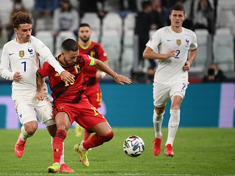 France's forward Antoine Griezmann (left) fights for the ball with Belgium's forward Eden Hazard during the UEFA Nations League semi-final football match at the Juventus stadium in Turin.