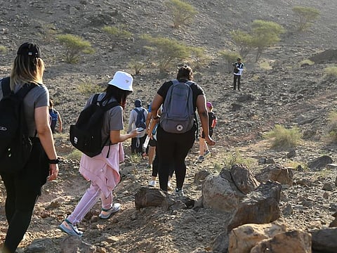 In line with the country’s celebrations of Expo 2020 Dubai, 320 volunteers from Dubai Police, including officers and civilians, and people of determination, alongside a team from Navy DXB fitness club, climbed up and down the Hatta mountain.