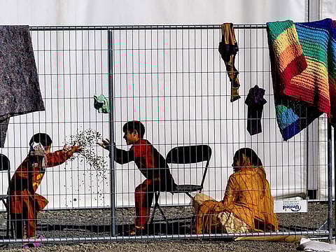 Children play with stones at an Afghan refugees camp on Joint Base McGuire Dix Lakehurst, N.J., on Monday, Sept. 27, 2021. The camp currently holds about 9,400 Afghan refugees and has a capacity to hold up to 13,000.
