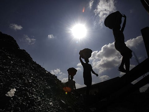 Indian labourers carry coal to load on a truck in Guwahati, India, in this file picture.