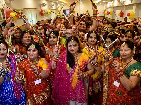 Women perform Dandia dance ahead of the Durga Puja festival at a puja pandal in Patna on October 3. Thousands of pandals are erected across the state during the nine-day-long Navratri festival and the government sees in them a golden opportunity to vaccinate the eligible population.