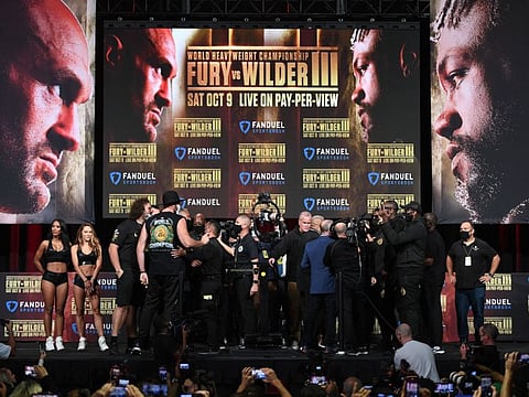 US challenger Deontay Wilder (right) and WBC heavyweight champion Tyson Fury of Great Britain gesture at each other after their weigh-in at MGM Grand Garden Arena in Las Vegas, Nevada.