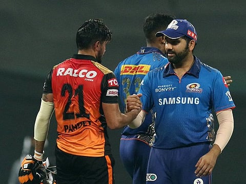 Skipper Rohit Sharma of the Mumbai Indians shakes hands with Sunrisers Hyderabad captain Manish Pandey after the IPL game in Abu Dhabi on October 8, 2021.