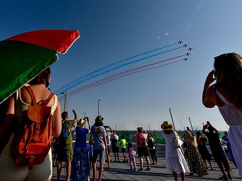 Visitors enjoy the Red Arrows aerobatic show by Royal Air Force at Expo 2020 Dubai on Friday.