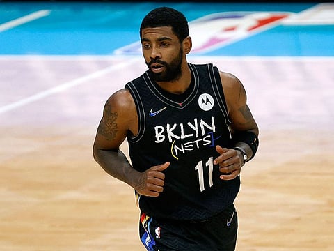 In this file photo taken on December 27, 2020 Kyrie Irving #11 of the Brooklyn Nets runs the court during the fourth quarter of their game against the Charlotte Hornets at Spectrum Center in Charlotte, North Carolina.