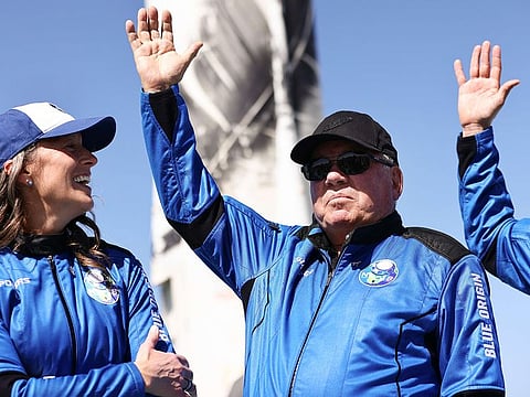 Blue Origins vice president of mission and flight operations Audrey Powers (L) looks on as Star Trek actor William Shatner waves during a media availability on the landing pad of Blue Origin’s New Shepard after they flew into space on October 13, 2021 near Van Horn, Texas.