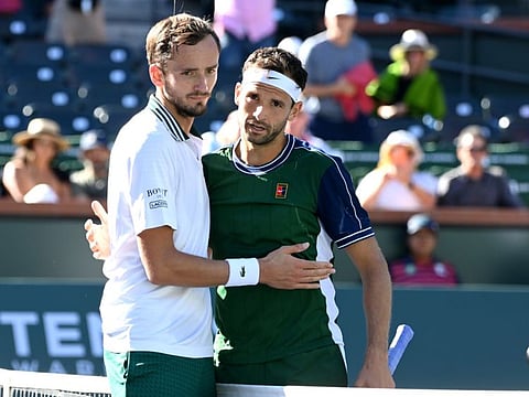 Daniil Medvedev (left) shakes hands with Grigor Dimitrov after their fourth round match during the BNP Paribas Open at the Indian Wells Tennis Garden.