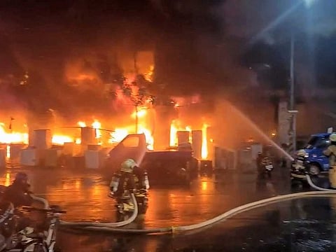 In this image taken from video by Taiwan's EBC, firefighters battle a blaze at a building in Kaohsiung, in southern Taiwan on Thursday, Oct. 14, 2021. The fire engulfed a 13-story building overnight in southern Taiwan, the island's semi-official Central News Agency reported Thursday.