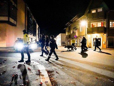 Police officers cordon off the scene where they are investigating in Kongsberg, Norway after a man armed with bow killed several people before he wasarrested by police on October 13, 2021.