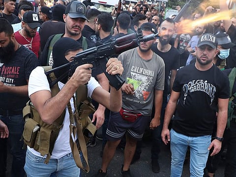 Supporters of the Shiite Amal group fire weapons in the air during the funeral processions of Hassan Jamil Nehmeh, who was killed during Thursday’s clashes, in the southern Beirut suburb of Dahiyeh on October 15, 2021.